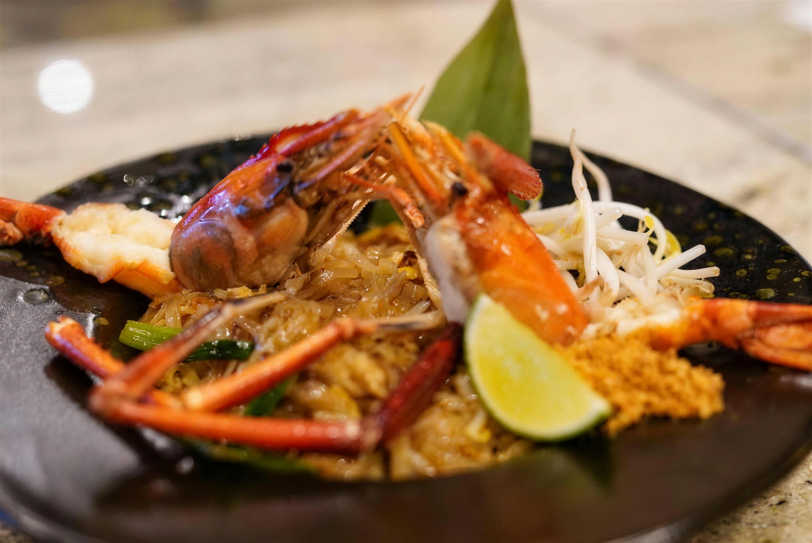 Shrimp pad thai with head-on prawn and lime
